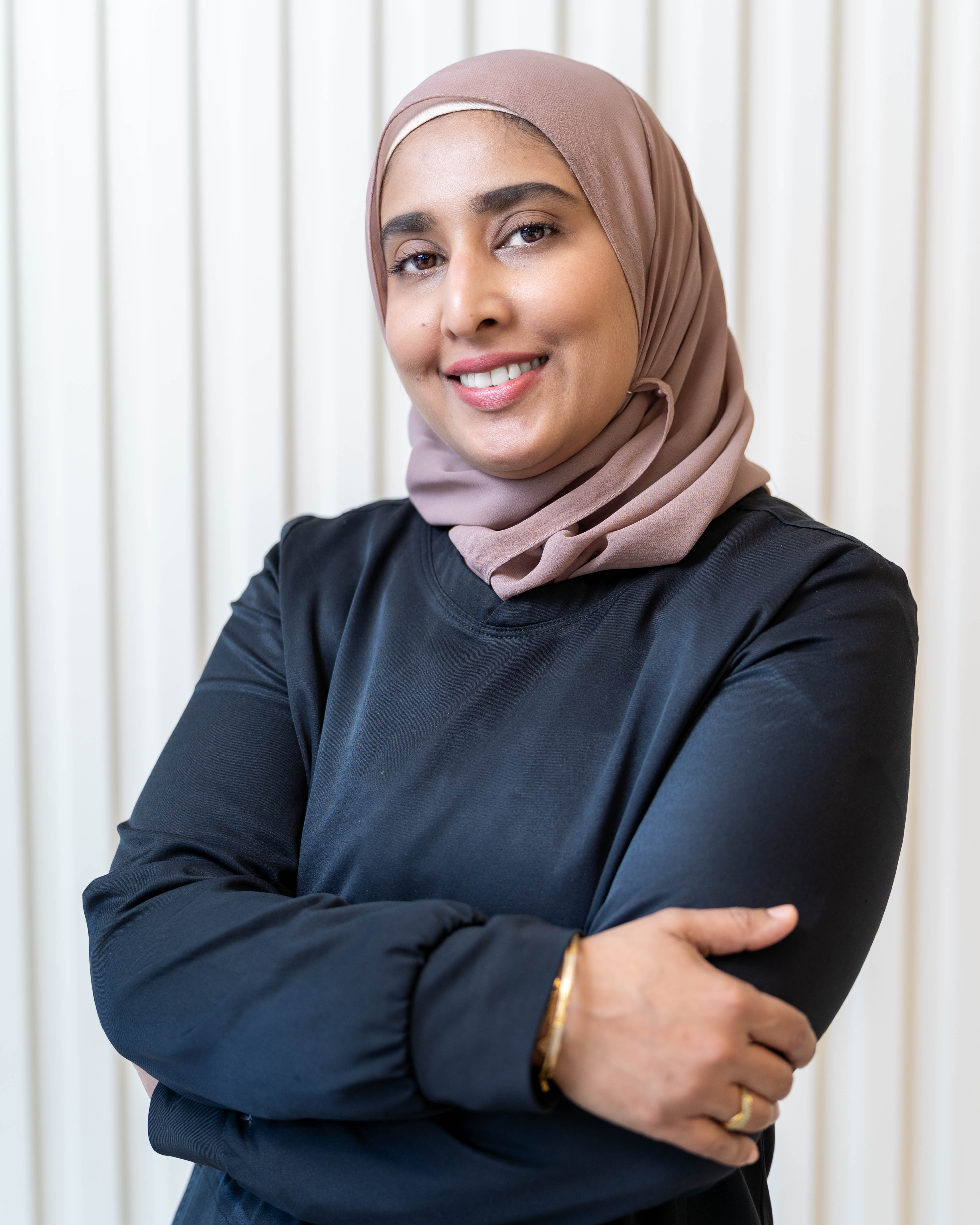 Dr. Faiza Urooj smiling in the SmileHaven clinic